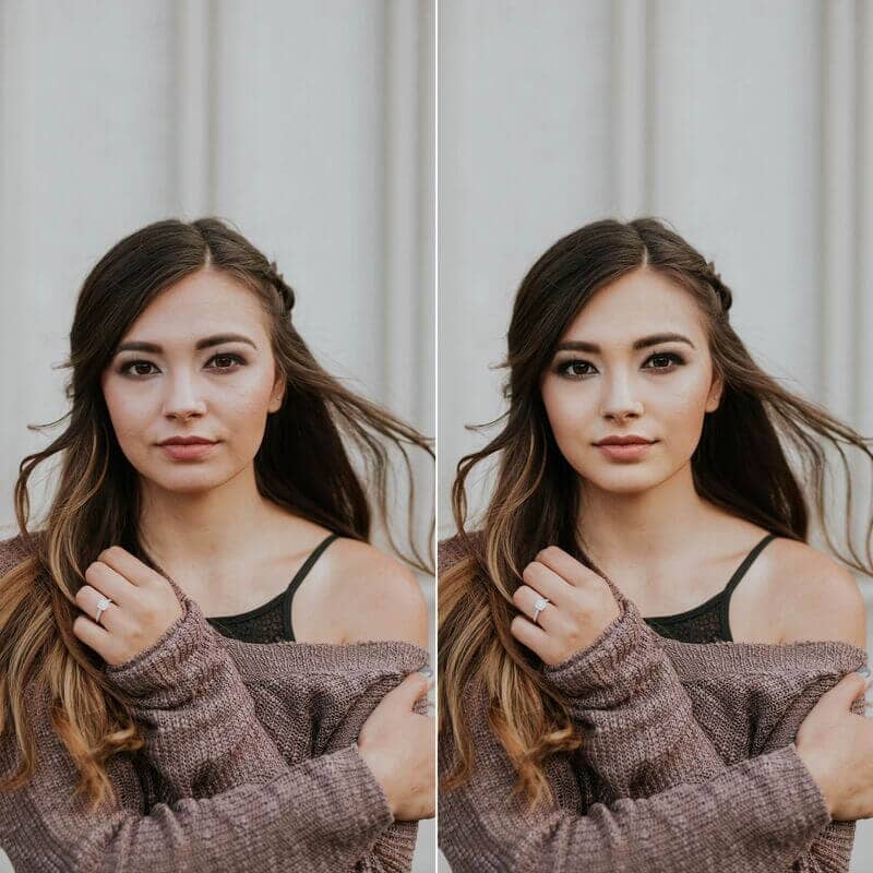 Woman with dark hair wearing a black tank top and taupe sweater