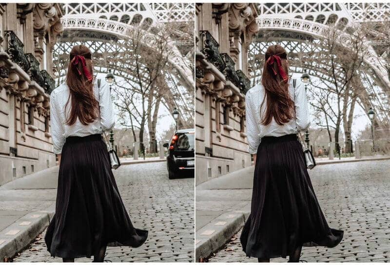 Woman wearing a black shirt and white shirt standing in front of the Eiffel Tower