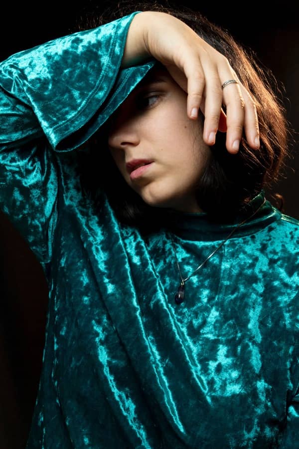 Foto de una mujer con una blusa verde.