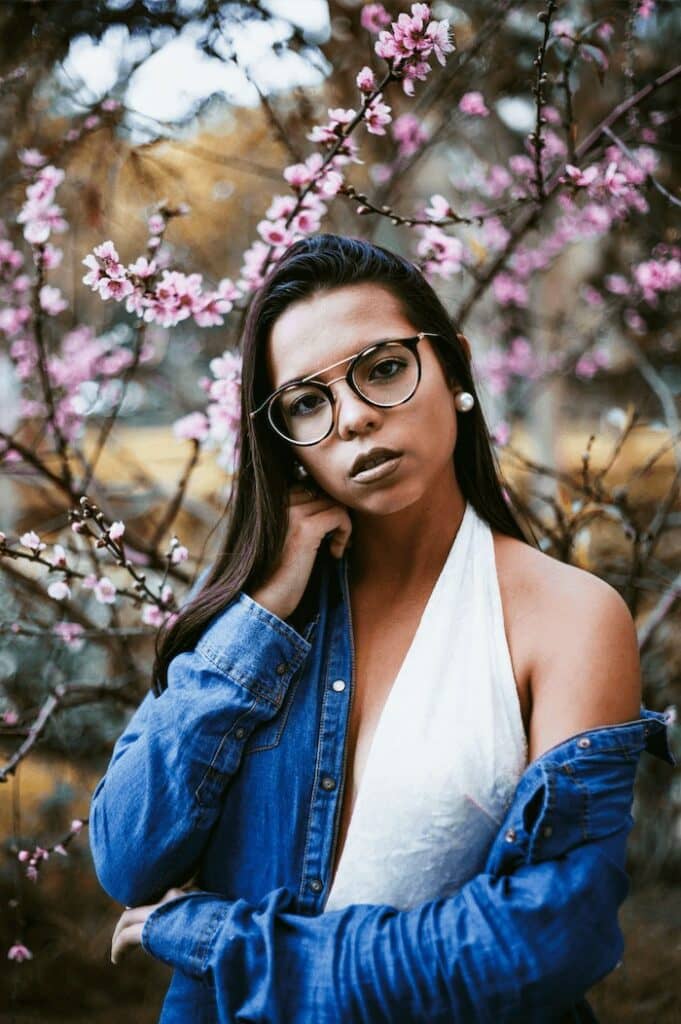 woman in denim jacket and white halter dress