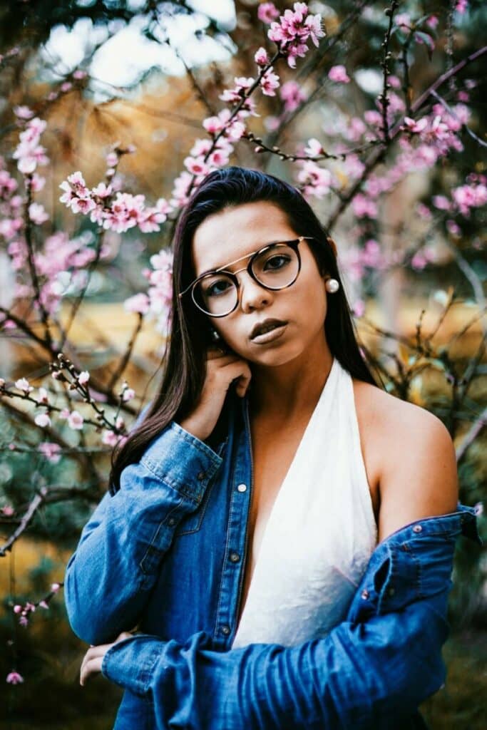 woman in denim jacket and white halter dress