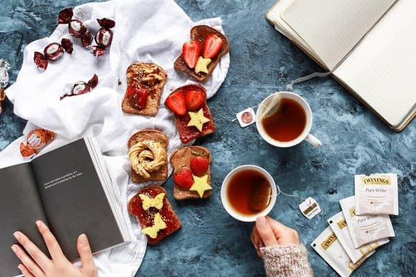 breakfast flat lay with french toast, fruits and tea