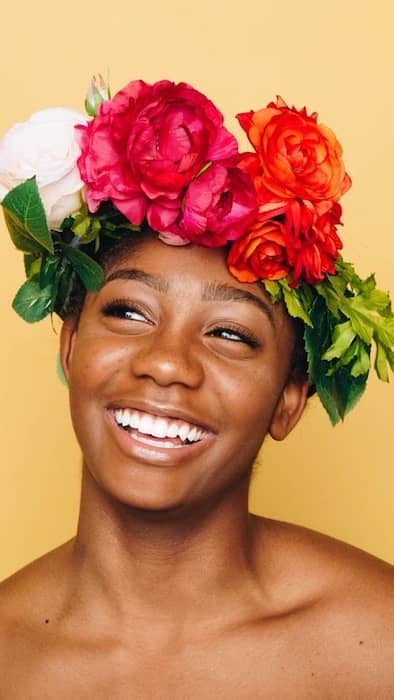 Picture of bald black woman with a crown of flowers