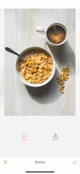 Picture of a bowl with cereal and a cup of coffee being edited by AirBrush with the Rotate Tool