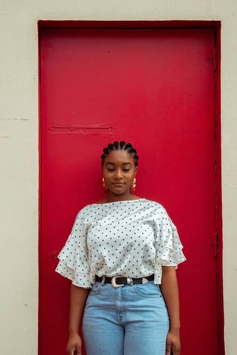 woman standing in front of a red door