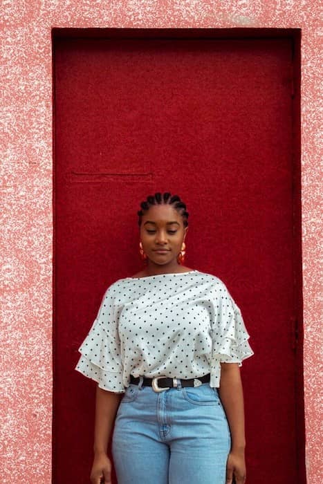 woman standing in front of a red door