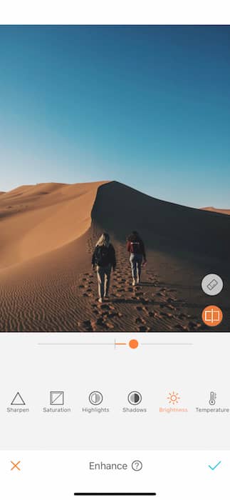 two women walking on a sand dune