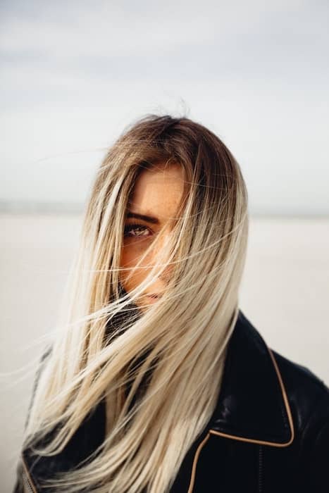 woman with blonde hair blowing in her face