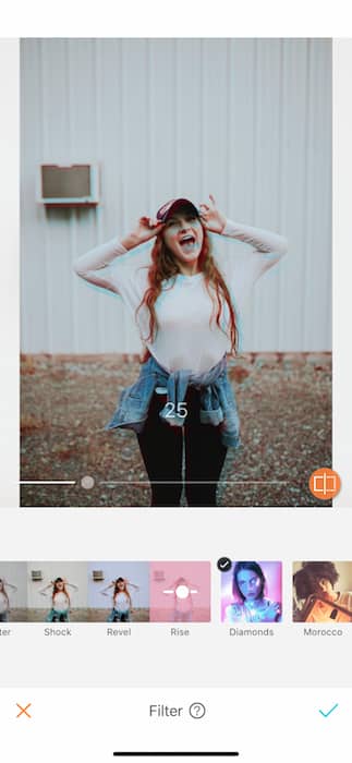 blurry photo of woman laughing wearing a white shirt and cap