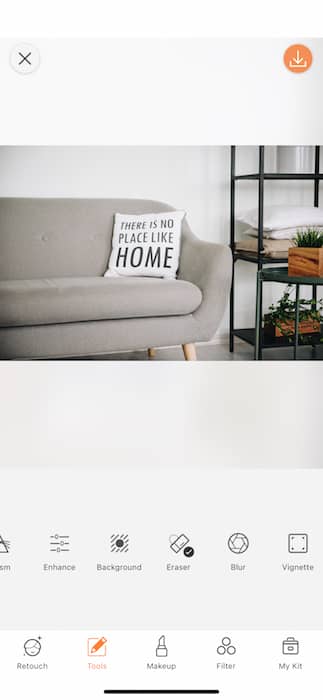 gray sofa with pillow that says "There's no place like home"