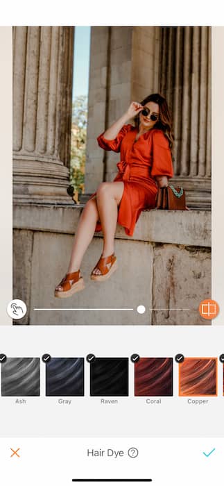 woman wearing orange dress posing in front of pillars