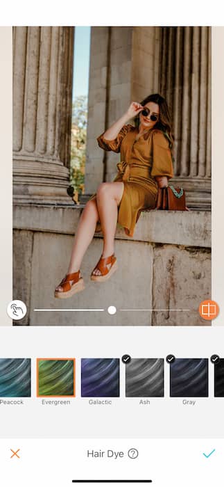 woman wearing gold dress posing in front of pillars