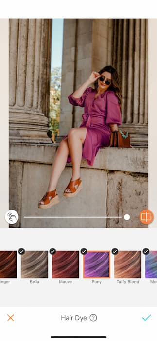 woman wearing pink dress posing in front of pillars