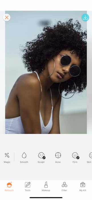 black woman wearing sunglasses and a white tank top