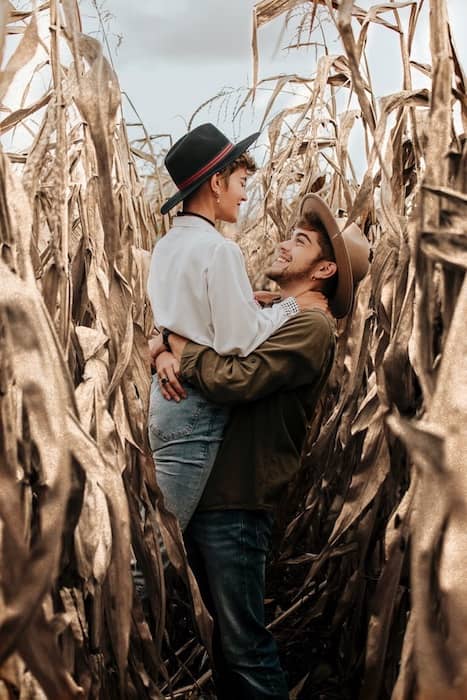 smiling couple embracing in a corn field