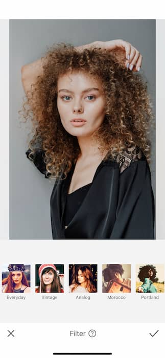 picture white woman with curly hair being edited by AirBrush with filter