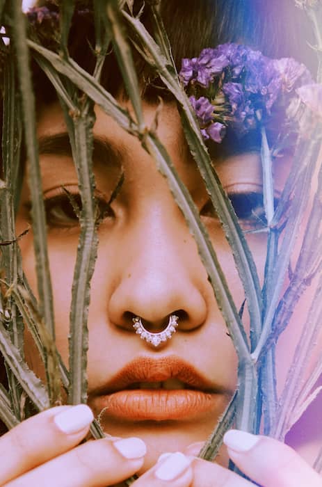 Picture of a woman with flowers close to her face with the Skyline Filter