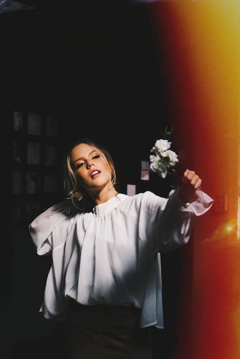 Picture of a white woman holding flowers with the Burn Filter