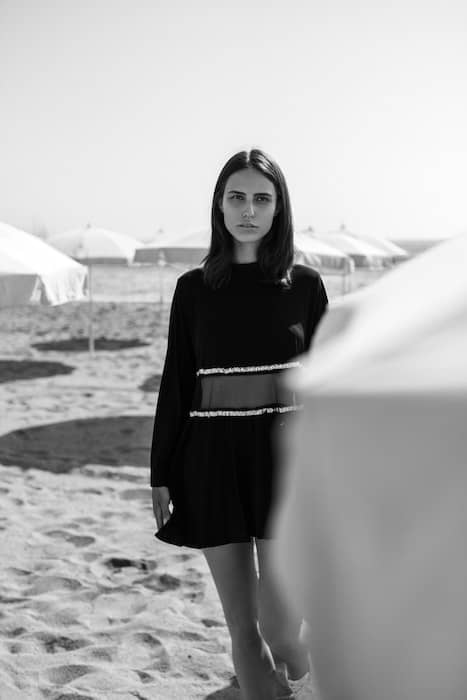 A black and white picture of a woman in a beach