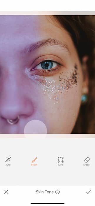 It's an image of a white girl, with blue eyes and glitter in her eyes, being edited with AirBrush App.