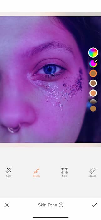 It's an image of a white girl, with blue eyes and glitter in her eyes, being edited with AirBrush App.