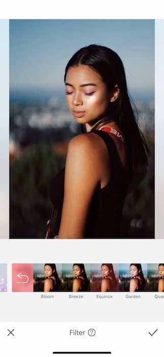 Picture of a woman posing and looking down being edited by AirBrush