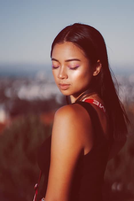 Picture of a woman posing and looking down being edited by AirBrush