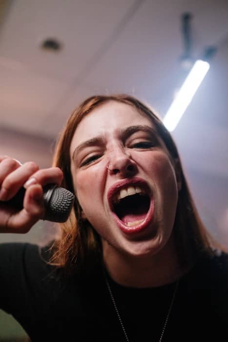 woman screaming into a microphone