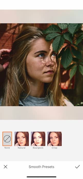 Picture of a blonde girl with plants in her eyes being edited by AirBrush