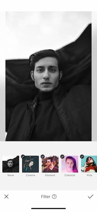 black and white photo of man with dark hair in front of black and white background