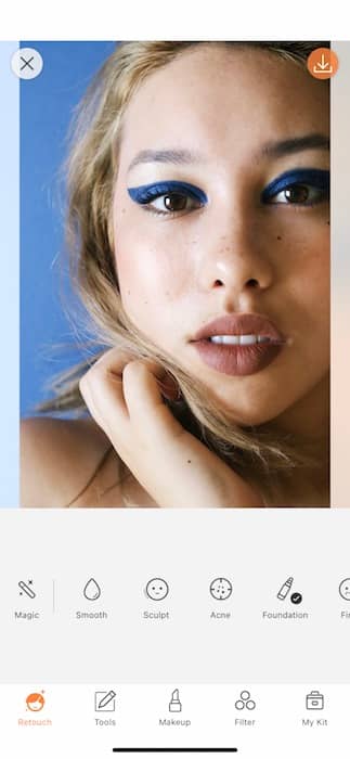 closeup of woman with blonde hair and blue eyeliner in front black background