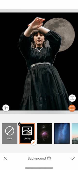 woman wearing a black dress standing in front of the moon