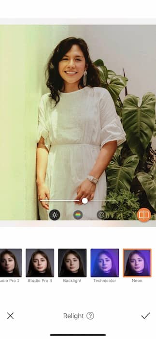  woman in a white dress standing in front of a colorful background