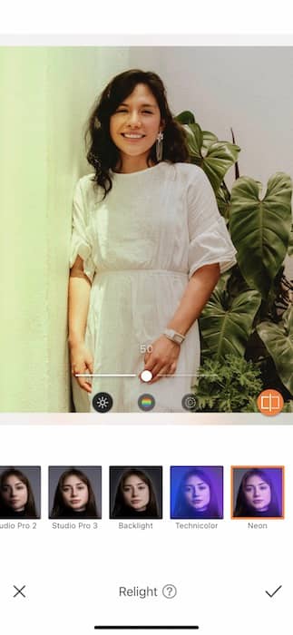  woman in a white dress standing in front of a colorful background