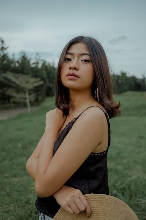 woman standing in green field