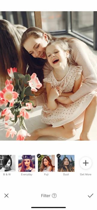 mother hugging toddler daughter and laughing