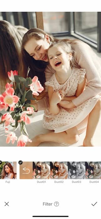 mother hugging toddler daughter and laughing