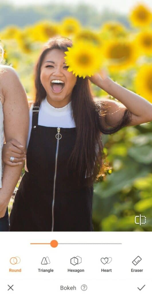 laughing woman holding a sunflower