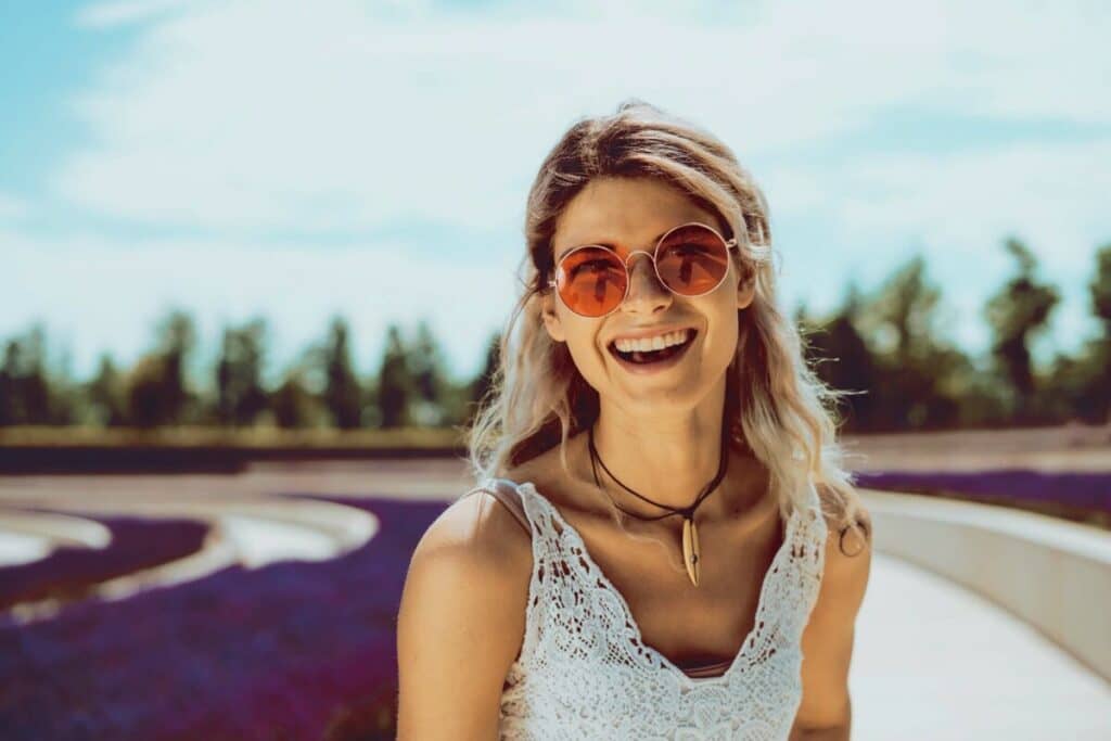 Aquarius horoscope edit of a woman laughing in a lavender field