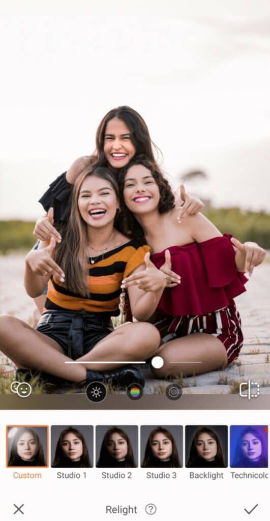 Group Photo of three smiling women taking a photo on the beach