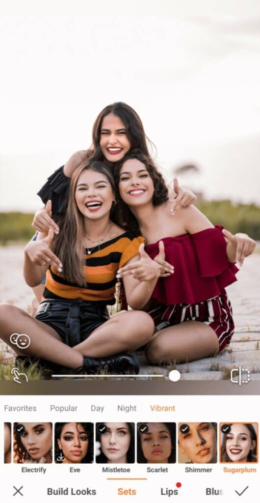 Group Photo of three smiling women taking a photo on the beach