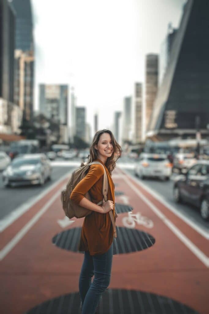 woman standing in the middle of a busy city street