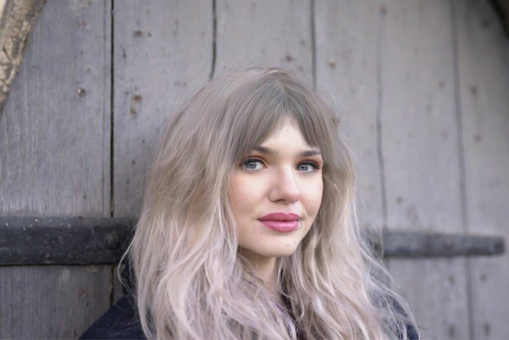 woman with blonde hair and curtain bangs