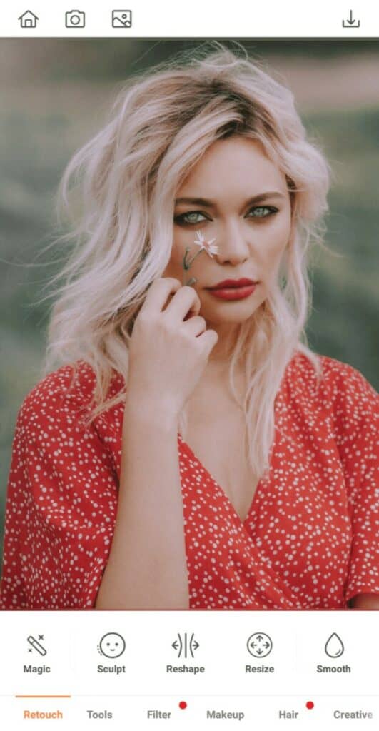 woman with blonde hair holding a flower