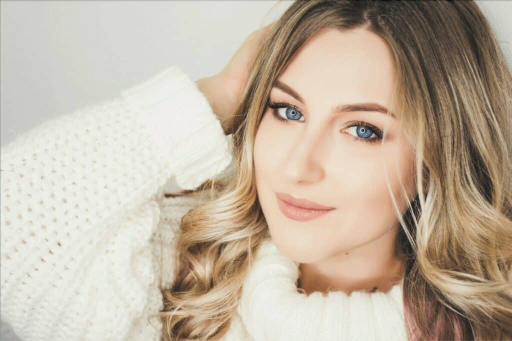 blonde woman wearing a white sweater