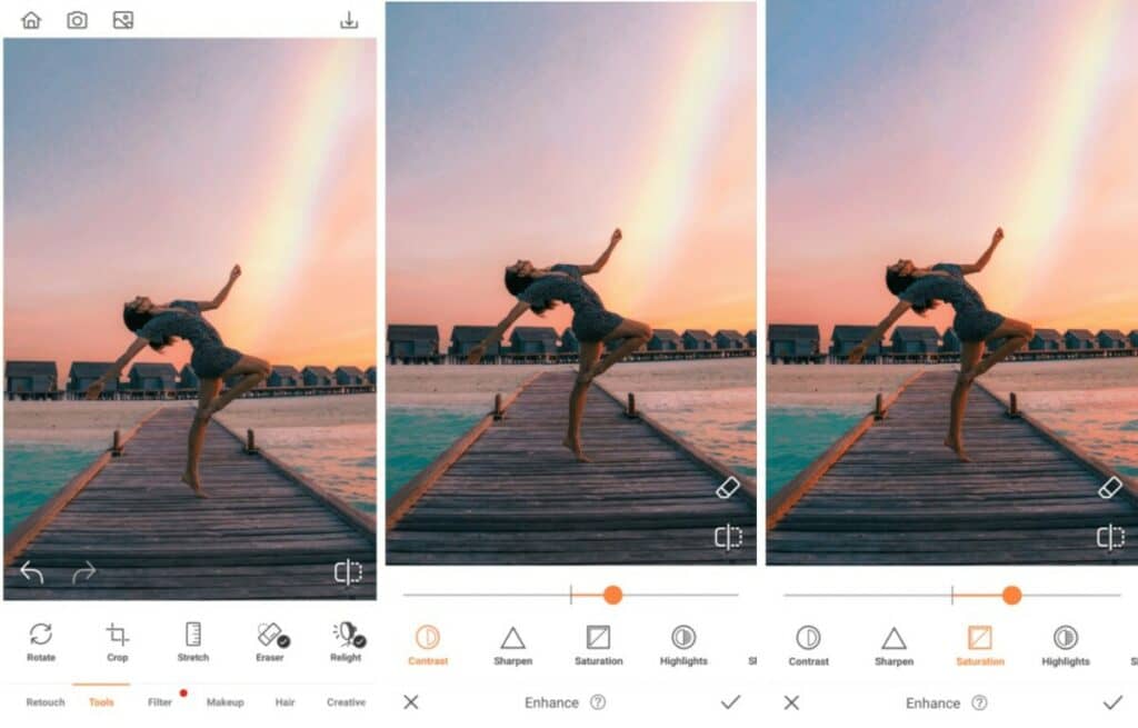 woman posing on a jetty with a rainbow in the sky 