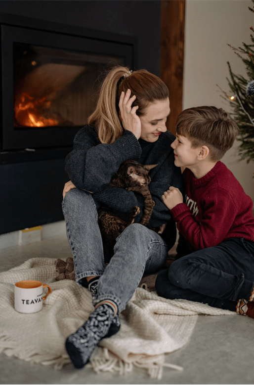 woman and child sitting in front of fire