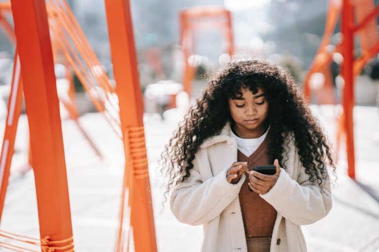 Black woman using her cell phone
